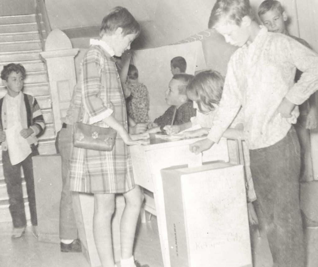 Photo of elementary school group casting their vote for school leaders.